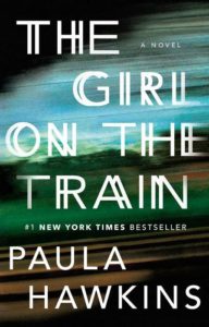 A book cover featuring the title "the girl on the train," noted as a new york times bestseller, by author paula hawkins, set against a backdrop suggestive of a speeding train's motion blur.