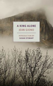 A mystical mountain shrouded in fog, evoking solitude and the majesty of nature, sets a backdrop for the title "a king alone" by jean giono, with an introduction by susan stewart.