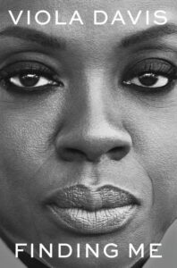 An intense black and white close-up portrait of a woman with prominent text displaying "viola davis finding me.