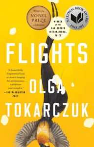 A book cover featuring the title "flights" by olga tokarczuk, with an artistic depiction of bird feathers in motion on a vivid yellow background, highlighting the book's themes of travel and movement. awards the book has won, including the nobel prize in literature and the man booker international prize, are also displayed at the top.