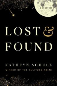 A book cover for "lost & found," a memoir by kathryn schulz, decorated with a night sky motif and a gold ampersand symbol, highlighting that the author is a winner of the pulitzer prize.