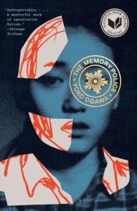 A visually evocative book cover of "the memory police" by yoko ogawa, featuring a stylized image of a woman's face fragmented by geometric shapes, overlaid with text and critical acclaim against a textured background.
