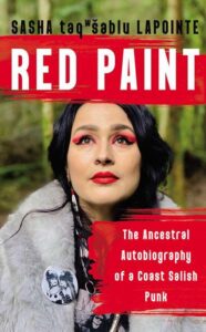 A woman with distinctive red eye makeup and a white fur collar gazes thoughtfully upwards, set against a natural backdrop, on the cover of sasha taqʷšəblu lapointe's book "red paint: the ancestral autobiography of a coast salish punk.