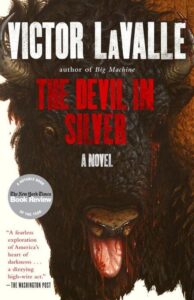 A book cover for "the devil in silver" by author victor lavalle, featuring a close-up illustration of a bison with intense eyes and a menacing presence, along with critical acclaims and accolades highlighting it as a notable book.
