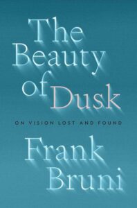 A book cover with a serene blue backdrop featuring the title "the beauty of dusk" in elegant white and peach lettering that casts a shadow to create a sense of depth, followed by the subtitle "on vision lost and found" and the author's name, frank bruni, at the bottom.