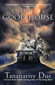 A moody and atmospheric book cover for "the good house" by tananarive due, featuring a looming house silhouette against a dramatic sky with a lone tree.