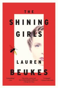 The shining girls" by lauren beukes book cover featuring a woman's face and a silhouette of a fly, with critical acclaim quotes from time, chicago sun-times, and national public radio.