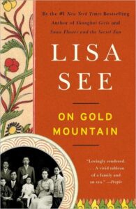 Cover of lisa see's novel "on gold mountain," featuring a family portrait and decorative floral patterns on the borders.