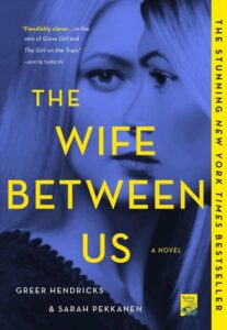 A captivating book cover featuring a woman's silhouette overlaid on bold text, promoting "the wife between us" - a psychological thriller acclaimed as a new york times bestseller.