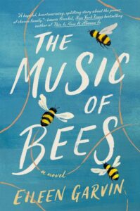 A book cover titled "the music of bees" by eileen garvin with three bees hovering against a light blue backdrop with whimsical white text.