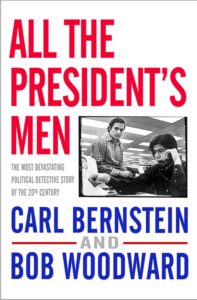 The image is the cover of the book "all the president's men" by carl bernstein and bob woodward, featuring a monochrome photograph of two men, presumably the authors, working together, with the title in large red letters on a white background. the cover touts the book as the most devastating political detective story of the century.