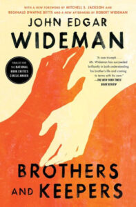 A book cover of "brothers and keepers" by john edgar wideman with a vibrant background and text overlay, featuring a striking graphic design of interlocked hands.