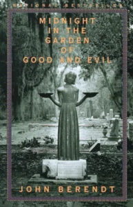 A book cover titled "midnight in the garden of good and evil" by john berendt, featuring an image of a statue of a young girl with outstretched arms in a hauntingly serene graveyard setting.