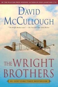 The cover of a book titled "the wright brothers" by david mccullough, featuring an image of the wright brothers' early airplane in flight.