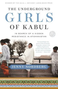 A group of girls playing on a seesaw, with a clear sky in the background, for a book cover titled "the underground girls of kabul: in search of a hidden resistance in afghanistan" by jenny nordberg.