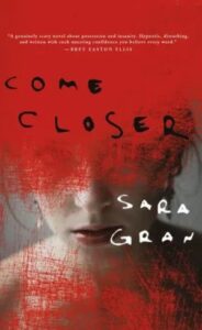 A chilling book cover, depicting a woman's face partly obscured by red smudges or scratches, hinting at horror or turmoil. the title "come closer" by sara gran promises a gripping tale.