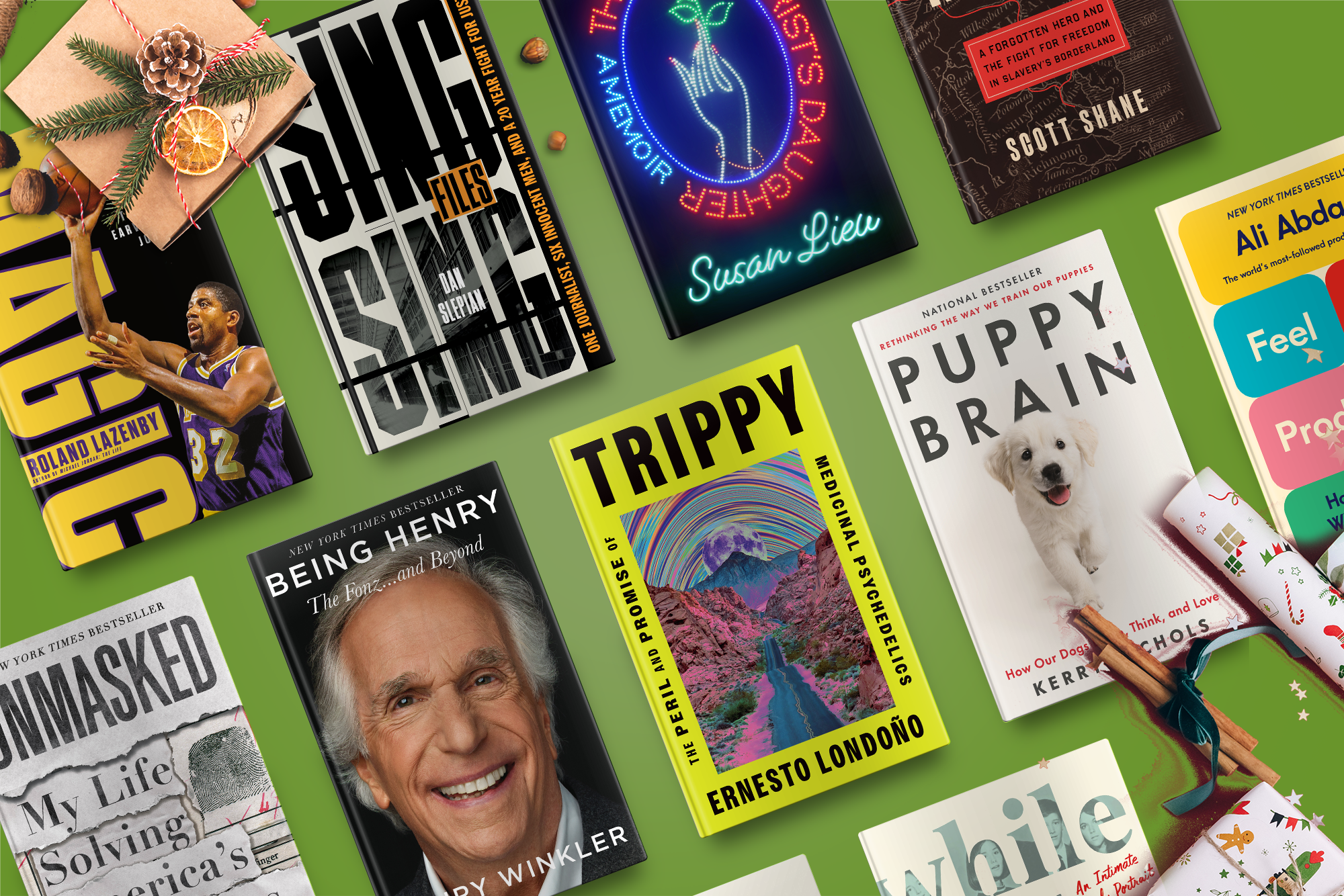 Books laid out on a green surface, including titles like "Trippy," "Puppy Brain," and "Whole" with diverse themes and covers.