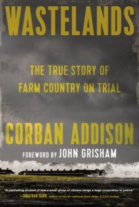Book cover of "wastelands: the true story of farm country on trial" by corban addison with a foreword by john grisham, featuring a dramatic image of a barren field under a cloudy sky, indicating a theme of agricultural struggle and legal drama.