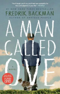 A man stands with his back to the viewer, looking out into the distance, accompanied by a small cat at his feet—a peaceful moment captured on the cover of fredrik backman's bestselling novel 'a man called ove'.
