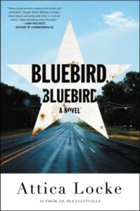 A road stretches into the distance under a dramatic sky on the cover of "bluebird, bluebird," a novel by attica locke.