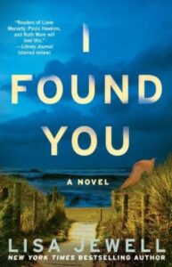 A book cover for the novel "i found you" by lisa jewell, featuring the title in large white letters against a blue sky with an image of a desolate beach path leading to the sea below.