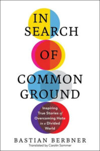 A book cover titled "in search of common ground" by bastian berbner, featuring colorful overlapping circles symbolizing unity and diversity, with a subtitle that reads "inspiring true stories of overcoming hate in a divided world," and a note indicating it's translated by carolin sommer.