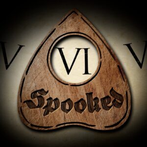 An intricately carved wooden placard with the word "spooked," featuring roman numerals "vi" on either side, conjuring a sense of eerie mystique.