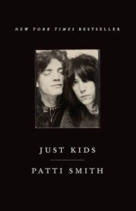 Intimate black and white portrait of a man and woman on the cover of the new york times bestseller 'just kids' by patti smith.