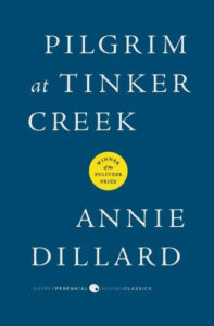 A book cover of "pilgrim at tinker creek" by annie dillard, hailed as a winner of the pulitzer prize, featured in the harper perennial modern classics series. the cover is simple with a blue background and white text, with an accent color circle highlighting the award the book has won.
