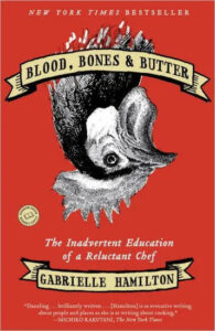 A book cover with a title "blood, bones & butter: the inadvertent education of a reluctant chef" by gabrielle hamilton, featuring a striking illustration of a chicken on a bold red background, indicating a memoir about culinary life.