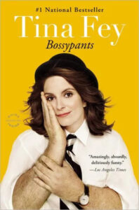 An expressive woman posing with her hand on her cheek and crossed arms, against a yellow background, for the cover of her book titled "bossypants.