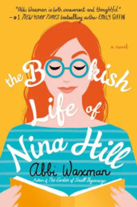 A colorful book cover illustration for "the bookish life of nina hill" by abbi waxman, featuring a stylized representation of a woman with glasses, her eyes closed, and a serene expression, holding a striped orange and blue book in front of her. the title and author's name are displayed prominently, along with a praise quote from bestselling author emily giffin.