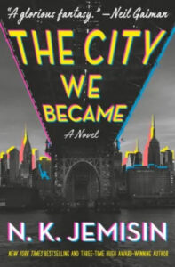 A vibrant book cover for "the city we became," a novel by n. k. jemisin, featuring the silhouette of a bridge and a city skyline against a neon-colored background, with accolades from neil gaiman.