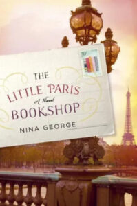 A novel set in the heart of france: "the little paris bookshop" by nina george, capturing the essence of paris with its iconic eiffel tower and classic street lamps.