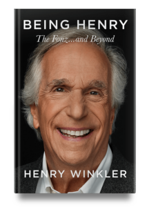 Portrait of a joyful man on the cover of his biography titled 'being henry - the fonz...and beyond' by henry winkler.