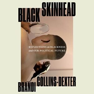 An evocative book cover with strong visual metaphors, showcasing a person examining their own reflection through a magnifying glass, symbolizing introspection and analysis of black identity and political future.