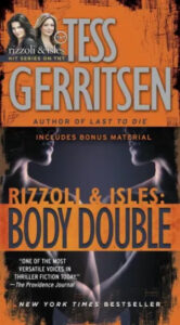 A book cover for "rizzoli & isles: body double" by tess gerritsen, featuring the silhouettes of two people against a split backdrop of orange and black, with promotional text indicating bonus material and a quote praising the author.
