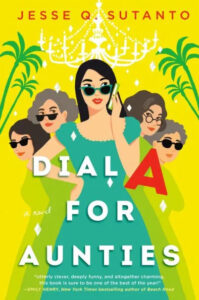 A colorful book cover illustration for "dial a for aunties" by jesse q. sutanto, featuring a stylish woman holding a mobile phone, flanked by four amused-looking aunties amidst a tropical backdrop with palm fronds and decorative elements.