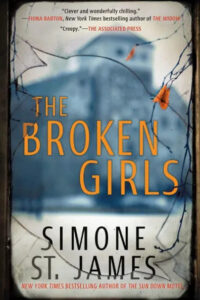 The image shows a book cover with a slightly eerie and mysterious ambiance. the title "the broken girls" is prominently displayed in the center with the author's name, simone st. james, just below it. the background seems like an old, distressed window with spiderwebs in the corners, suggesting elements of suspense or horror within the novel. praise for the author's work from fiona barton and the associated press is included at the top, indicating positive reception for previous works.