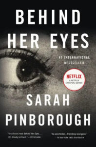 A haunting book cover for "behind her eyes" by sarah pinborough, featuring a close-up of a woman's eye with the title and author's name overlaid, and endorsements from stephen king and the new york times book review, also promoting the netflix series adaptation.