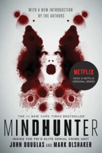 Book cover of "mindhunter: inside the fbi's elite serial crime unit" by john douglas and mark olshaker, promoting its adaptation into a netflix original series, with a foreboding design featuring blood spatter.