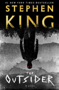 A haunting book cover for stephen king's novel "the outsider," featuring an inverted figure with hints of a mysterious red presence.