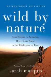 A traveler treks across a vast desert landscape on the cover of "wild by nature" by sarah marquis, capturing the essence of adventure and exploration.