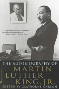 A book cover featuring a prominent portrait of martin luther king jr., with a smaller inset image of him speaking, titled "the autobiography of martin luther king, jr.," edited by clayborne carson.