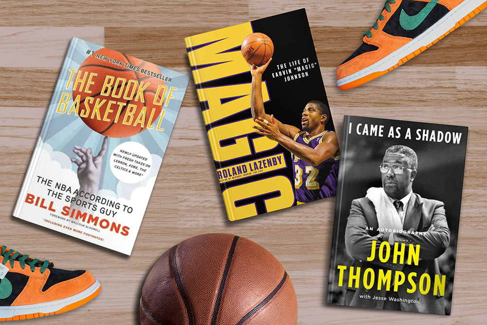 A collection of basketball-themed items, including books, a basketball, and a pair of sneakers, arranged on a wooden floor.