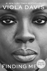 A monochromatic close-up of a woman's face, expressing a mix of strength and vulnerability, on the cover of "finding me," a new york times bestseller, and an oprah's book club pick for 2022.