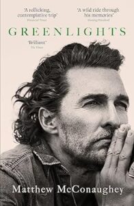 A contemplative man with a beard, resting his head on his hand, on the cover of the book "greenlights" by matthew mcconaughey.