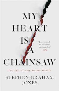 A book cover featuring a title "my heart is a chainsaw" by stephen graham jones, with a torn, jagged line across the middle, suggesting suspense or horror.