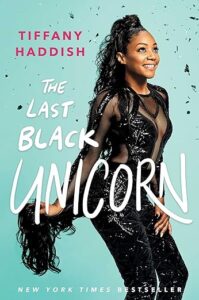 A woman posing confidently in an elegant black outfit against a teal background, with the title "the last black unicorn" by tiffany haddish featured prominently, signifying a new york times bestseller.