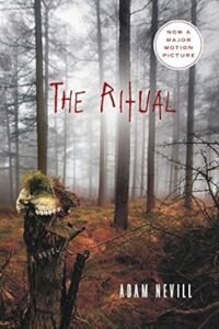 A misty forest with bare trees sets a chilling scene on the cover of "the ritual" by adam nevill, highlighted by an ominous animal skull atop a stake, hinting at the horror that lies within the pages.